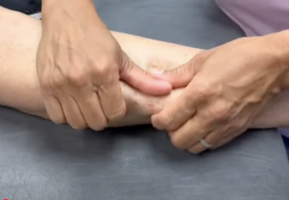 Person massaging arm for therapy or relaxation